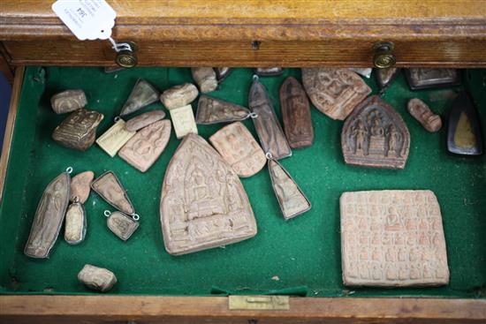 A collection of Buddhist terracotta amulets, chest 82cm